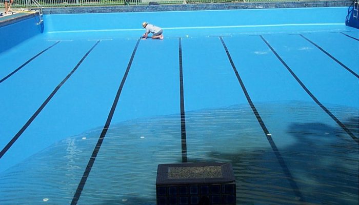 During: Painting the swimming lanes as the pool is filling.