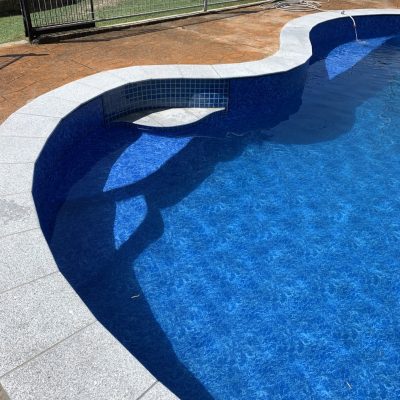 Finished with a new light grey Granite coping and Pacific Waves pool liner.