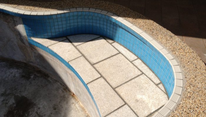 During: On this pool we replaced the tread tiles, new blue mosiacs and granite on the bench top